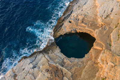 High angle view of rocks in sea