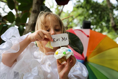 Girl holding cupcake