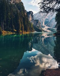 Scenic view of lake by trees against sky