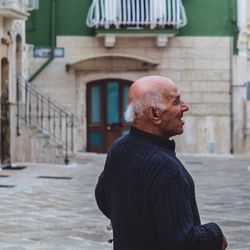 Man standing against building in city