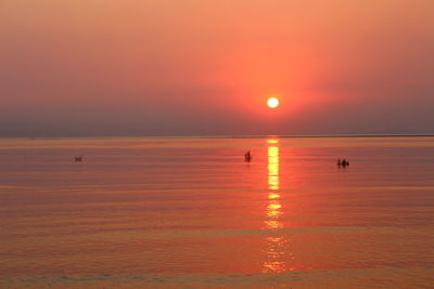 Scenic view of sea against orange sky