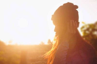 Portrait of man standing against sky during sunset