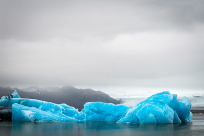 Blue floating on sea against sky