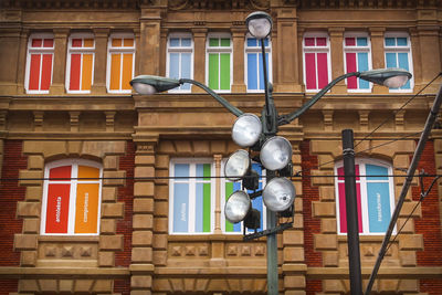 Low angle view of street light against building