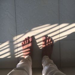 Low section of man legs on tiled floor