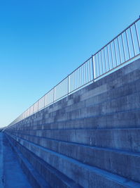 Low angle view of bridge against clear blue sky