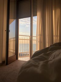 Scenic view of sea against sky seen through home window