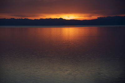 Scenic view of lake against sky during sunset