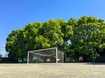 View of soccer field against clear blue sky