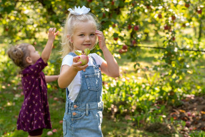 Girl holding ice cream standing outdoors