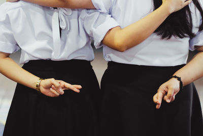 Midsection of couple holding hands