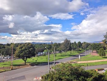 High angle view of road by trees against sky