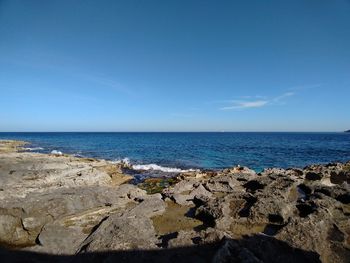 Scenic view of sea against blue sky