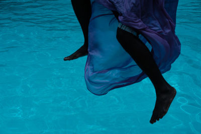 Low section of woman in swimming pool