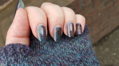 Close-up of cropped woman hand wearing woolen glove