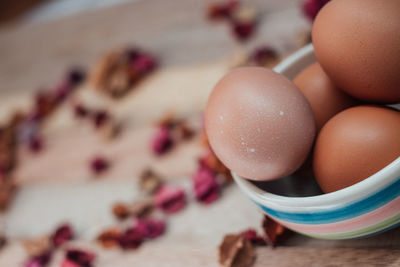 Close-up of eggs in bowl on wooden table