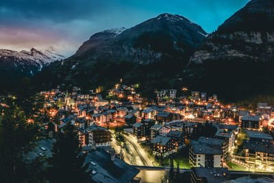 High angle view of illuminated buildings in city at night