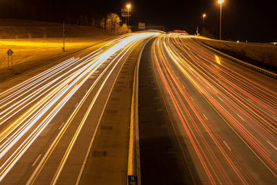 High angle view of light trails on road at night