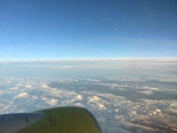 Cropped image of airplane wing over landscape