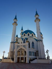 Low angle view of building against clear blue sky