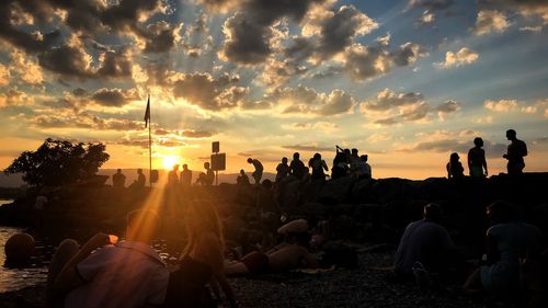 Group of people against sky during sunset