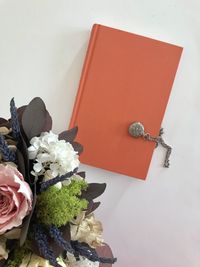 High angle view of red rose on white table