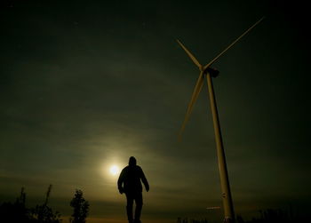 Rear view of silhouette man standing against sky during sunset