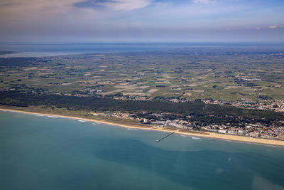 Aerial view of sea and landscape against sky