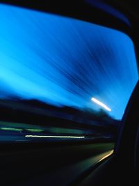 Light trails on road seen through car windshield