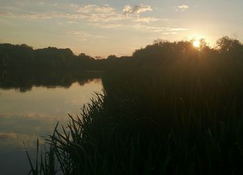 Scenic view of lake at sunset