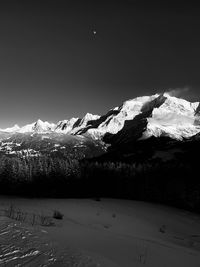 Scenic view of snow covered mountains against sky