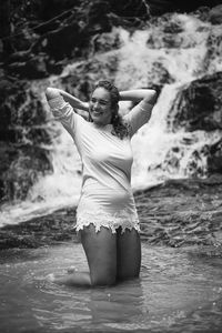 Portrait of woman standing in water