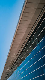 Low angle view of modern building against blue sky