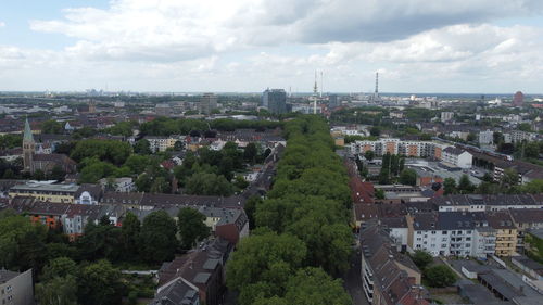 High angle view of buildings in city against sky