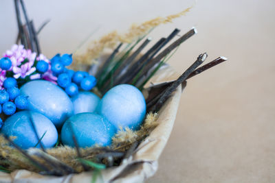 Close-up of multi colored eggs in basket