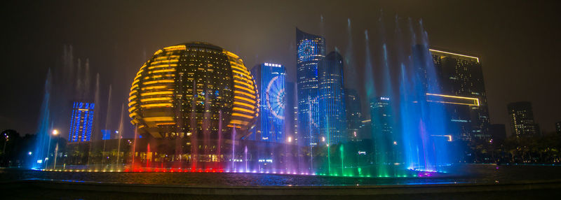 Illuminated buildings in city at night