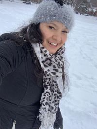 Portrait of smiling woman in snow