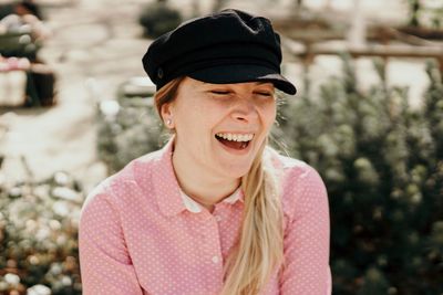 Close-up of smiling woman wearing cap