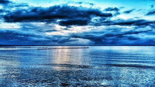 Scenic view of sea against cloudy sky