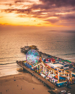 Ferris wheel at beach during sunset