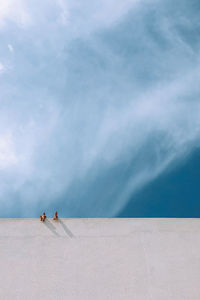 High angle view of people by swimming pool against sky