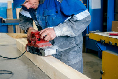 Midsection of man working in workshop