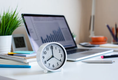 Close-up of clock on table