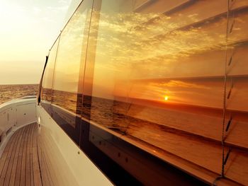 Sunset reflection on boat in sea