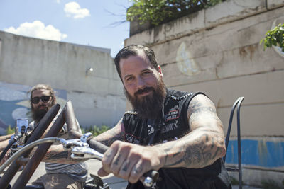 Two young men riding a motorcycle