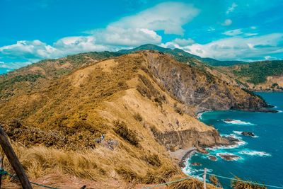 Scenic view of sea and mountains against sky