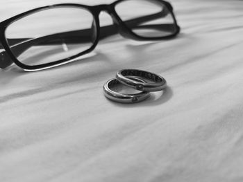 Close-up of wedding rings on table