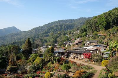 High angle view of houses along road on countryside landscape