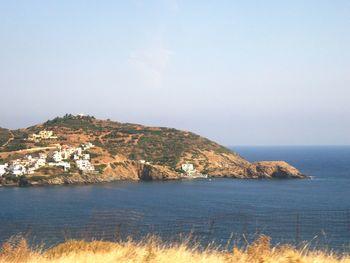 Scenic view of sea and mountains against clear sky