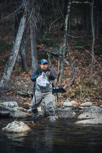 A man catches a trout during a morning on a maine river